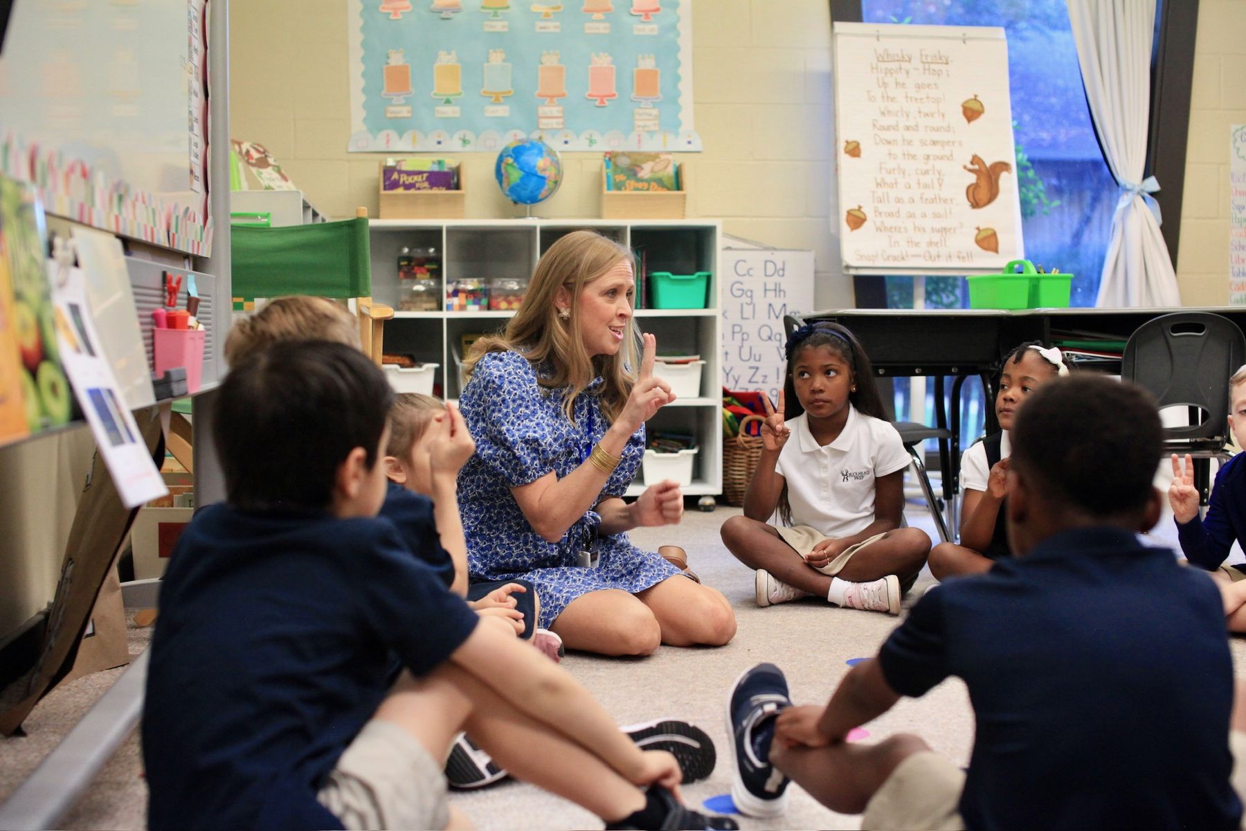 A teacher leading a lesson with students seated in a circle