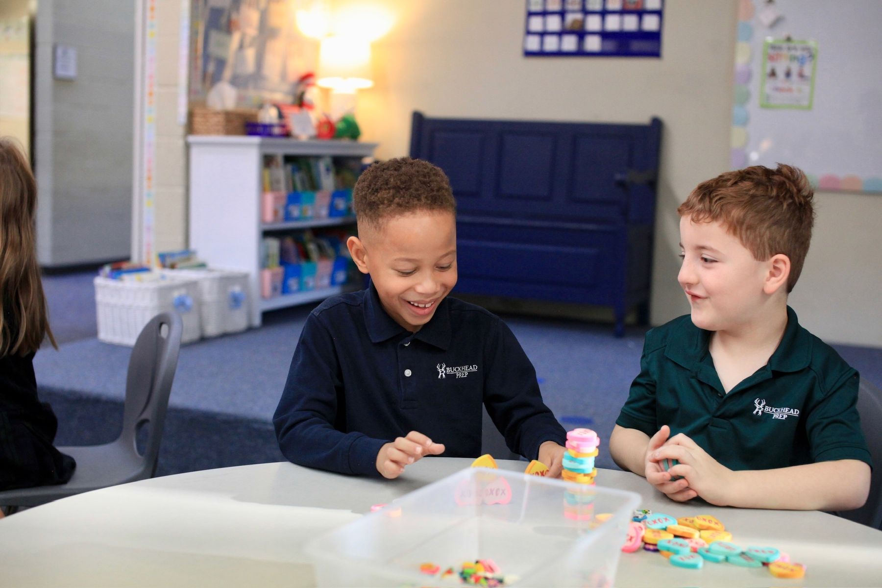 Two elementary students laughing over a math activity