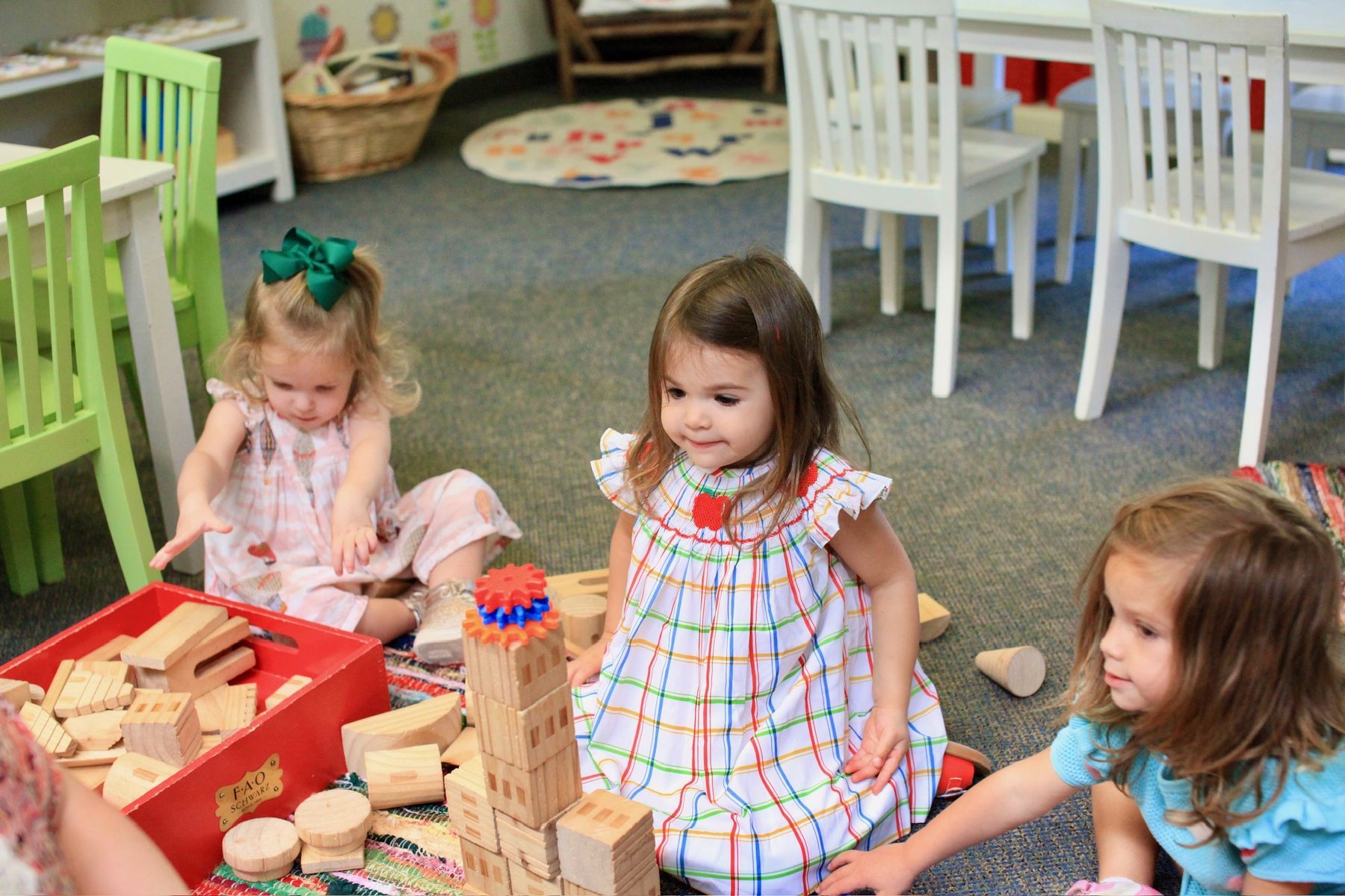 Toddlers building with wooden blocks in a Primary classroom